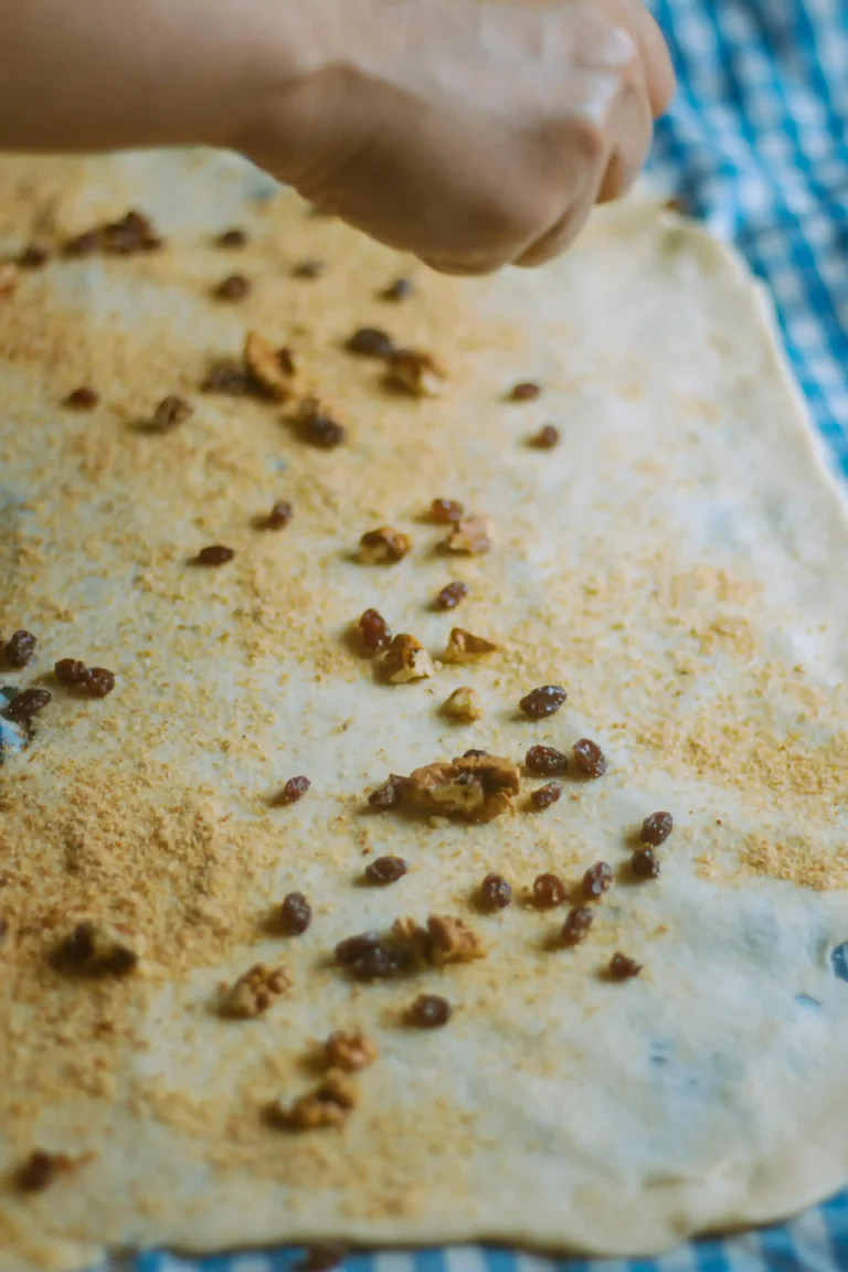 Loaf of bread with scattered breadcrumbs on a wooden table, symbolizing the concept of breadcrumbs navigation in SEO.